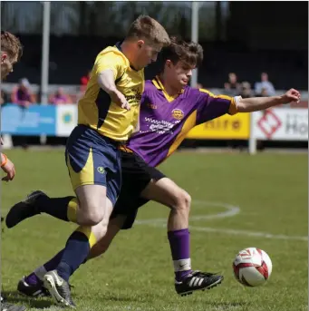  ??  ?? Sam O’Neill of Wexford Albion is tracked by Jason Ellard of Rosslare Rangers ‘B’.