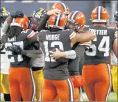  ?? KIRK IRWIN/AP ?? Cleveland Browns quarterbac­k Baker Mayfield (6) and wide receiver KhaDarel Hodge (12) hug after defeating the Pittsburgh Steelers.