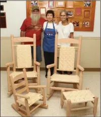  ?? The Sentinel-Record/Richard Rasmussen ?? HOMEMADE ROCKERS: Leon Sutton, left, makes heritage rocking. He was taught by Dallas Bump. His wife, Donna, right, weaves the bottom of the chairs and stools. With them is hostess Jo Spoerle.