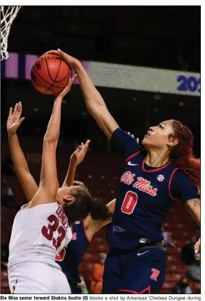  ?? (Photo courtesy of the SEC) ?? Ole Miss senior forward Shakira Austin (0) blocks a shot by Arkansas’ Chelsea Dungee during the Rebels’ victory over the Razorbacks on Thursday night at the SEC Women’s Tournament in Greenville, S.C. Austin finished with 29 points, 13 rebounds and 3 blocks.