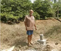  ?? Reuters ?? A farmer looks on as he stands beside a bullet train constructi­on mark laid out on his farm in Palghar. —