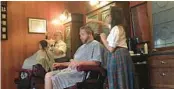  ?? ORLANDO SENTINEL DEWAYNE BEVIL/ ?? Magic Kingdom visitors get haircuts at the theme park’s Harmony Barber Shop in 2017. At the time, Disney said it had between 350 and 400 customers a week.