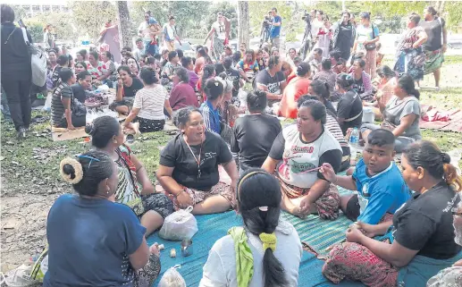  ??  ?? FINGERS CROSSED: On Jan 31, around 100 sea gypsies gathered in front of a Phuket court awaiting the verdict on four defendants’ land ownership case.