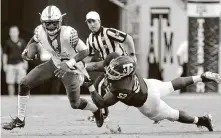  ?? Michael Wyke / Associated Press ?? Defensive lineman Justin Madubuike, right, and punter Braden Mann were the only A&M players to be chosen in the NFL draft.