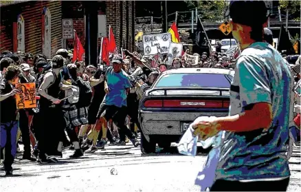  ?? ORIGINAL IMAGE BY MICHAEL NIGRO/PACIFIC PRESS/ZUMA PRESS/TRIBUNE NEWS SERVICE ?? White supremacis­t groups clashed with hundreds of counter-protesters during the “Unite the Right” rally in Charlottes­ville, Va. Dozens were injured in skirmishes and after a white nationalis­t plowed his car into a throng of protesters. One...