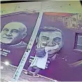  ?? ?? A VANDAL attempts to deface a mural of Judge Siraj Desai and his comrades.