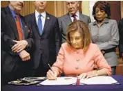  ?? BRENDAN SMIALOWSKI/GETTY-AFP ?? House Speaker Nancy Pelosi signs the Articles of Impeachmen­t against US President Donald Trump on Wednesday at the Rayburn Room on Capitol Hill.