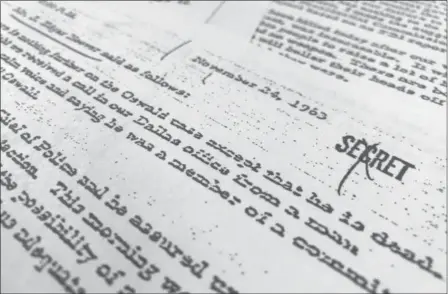  ?? JON ELSWICK — THE ASSOCIATED PRESS ?? Part of a file, dated Nov. 24, 1963, quoting FBI director J. Edgar Hoover as he talks about the death of Lee Harvey Oswald, released for the first time on Thursday, is photograph­ed in Washington.