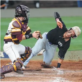  ?? Karen Warren photos / Houston Chronicle ?? Clear Springs’ Drew Minter, right, scrambles home for the only run of the game, slipping past Deer Park’s Reece Moon to score on Dylan Byrd’s sacrifice fly.