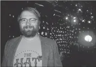  ?? ELIZABETH PATTERSON/CAPE BRETON POST ?? While the lights of the Highland Arts Theatre flash, “Disco Nights” writer Wesley Colford is shown here with a disco ball nearby for inspiratio­n.