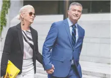  ?? WAYNE CUDDINGTON ?? Tim Tierney, councillor for Beacon Hill-Cyrville, arrives at the Elgin Street courthouse with his wife, Jenny, on Wednesday.