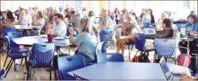  ?? Westside Eagle Observer/MIKE ECKELS ?? Teachers and staff from all four Decatur School District campuses gathered in the cafeteria at Decatur High School for the annual back to school breakfast Aug. 10. The new teachers were introduced during this session.