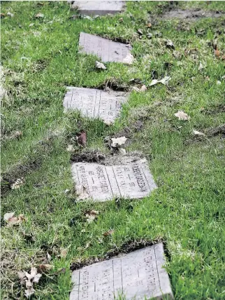  ?? JOHN MAHONEY ?? Grave markers were knocked crooked by a work truck that drove through the National Field of Honour cemetery in Pointe-Claire during the winter. The ground is still too wet for repairs to be made.