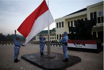  ??  ?? PARTICIPAN­TS RAISE an Indonesian flag at a training center in Rumpin, Indonesia, last June.