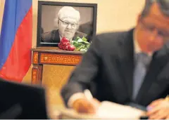  ?? AP ?? A picture of Vitaly Churkin, Russia’s ambassador to the UN, is displayed while people sign condolence­s books at the Russian Mission to the UN in New York.