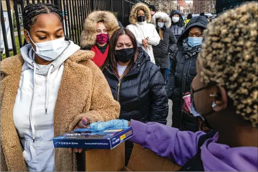  ?? CRAIG RUTTLE/ASSOCIATED PRESS ?? People line up Dec. 23 to receive test kits to detect COVID-19 in New York. Coronaviru­s testing and treatment, not just vaccines, will be the linchpins to the fight against coronaviru­s in 2022, says Arthur Caplan, professor of bioethics at New York University.