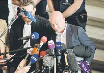  ??  ?? Sven Mary, the Belgian lawyer representi­ng Abdeslam, speaks to journalist­s on the last day of his trial, outside the courtroom at the courthouse in Brussels. — AFP photo