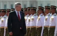  ?? SEAN KILPATRICK/THE CANADIAN PRESS ?? Prime Minister Stephen Harper inspects an honour guard as he meets with the Prime Minister of Malaysia Mohd Najib in Putrajaya on Sunday.