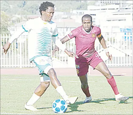  ?? ( Pic: Ntokozo Magongo) ?? Green Mamba’s Mthunzi Mkhontfo controls the ball while Manzini Wanderers’ Mthunzi Motsa closes in yesterday during the MTN Premier League game played at Mavuso Sports Centre. The game ended with a 1- all draw.