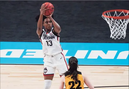  ?? Eric Gay / Associated Press ?? UConn guard Christyn Williams (13) shoots over Iowa guard Caitlin Clark (22) during the first half of their Sweet 16 game Saturday at the Alamodome in San Antonio.