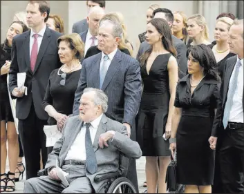  ?? Evan Vucci The Associated Press ?? Former Presidents George H.W. Bush and George W. Bush and family members watch pallbearer­s carry the casket of former first lady Barbara Bush after her funeral in Houston.