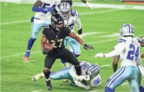  ?? TOMMY GILLIGAN/USA TODAY SPORTS ?? Ravens running back J.K. Dobbins (27) cuts away from Cowboys defensive tackle Neville Gallimore (96) during the second half at M&T Bank Stadium on Tuesday.