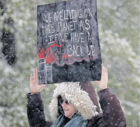  ??  ?? > A protester in Denver, Colorado, USA, at the People’s Climate March in April