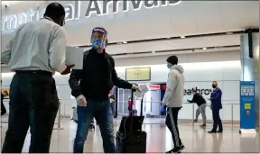  ??  ?? Passengers at Terminal 2 at Heathrow Airport as new quarantine measures come into force