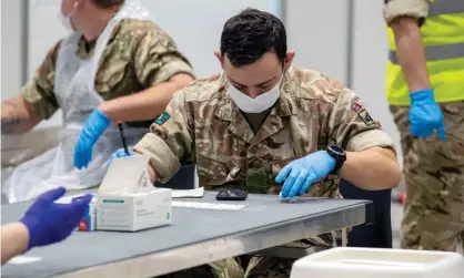  ?? Photograph: WPA/Getty Images ?? ‘In the UK, the government plans to roll out mass, cheap testing in the coming months.’ Soldiers assist in mass testing at Liverpool Exhibition Centre, 6 November.