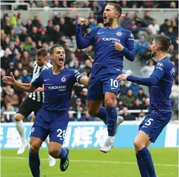  ?? (Reuters) ?? CHELSEA MIDFIELDER Eden Hazard (center) celebrates scoring his team’s first goal in the Blues’ 2-1 road win over Newastle United in Premiershi­p action last night.