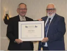  ?? ?? Jerome Niezgoda, president of the Saskatchew­an Catholic School Boards Associatio­n (left) presents the Julian Paslawski Meritoriou­s Service Award to Delmer Wagner for his work in Catholic education over 30 years. Wagner spent most of his career with Holy Trinity School Division. Photo submitted