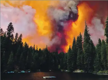  ?? ERIC PAUL ZAMORA — THE FRESNO BEE VIA AP ?? Smoke from the Creek Fire billows beyond a ridge as seen from Huntington Lake on Sept. 5. The federal government on Friday approved disaster aid for areas devastated by the Creek Fire and several other wildfires that erupted in September.