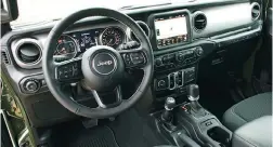  ??  ?? Inside the 2021 Jeep Wrangler 80th Anniversar­y edition, well equipped with the UConnect 4C system with Android Auto, Apple CarPlay, Nav & Sound Group. Interior cues include an Annodized Gunmetal instrument panel and Light Tungsten accents.