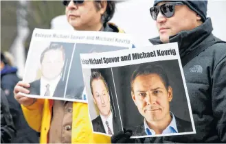  ?? REUTERS ?? People hold signs calling for China to release Canadian detainees Michael Spavor and Michael Kovrig during an extraditio­n hearing for Huawei Technologi­es Chief Financial Officer Meng Wanzhou at the B.C. Supreme Court in Vancouver.