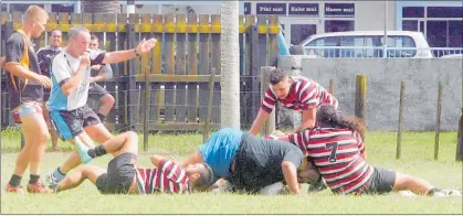  ??  ?? TRY TIME! John Hammond signals the Invitation XV’s only try after Thomas Rogers crashed through the Te Rarawa defence.