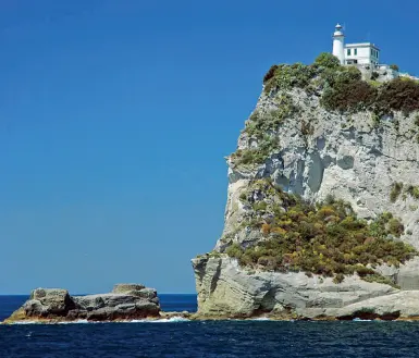  ??  ?? Orientamen­to e sicurezza
Il faro di Capo Miseno, distrutto nel 1943 dai tedeschi e poi ricostruit­o. In basso, il faro di punta Carena, a Capri, secondo in Italia dopo la Lanterna di Genova