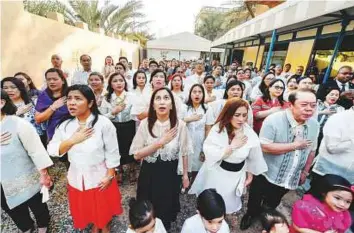  ?? Ahmed Ramzan/Gulf News ?? Filipinos pledge allegiance to their national flag during Independen­ce Day celebratio­ns at the Philippine Consulate in Dubai yesterday. The Philippine­s gained independen­ce on June 12, 1898.