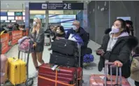  ?? JULIEN MATTIA / VIA GETTY IMAGES ?? Chinese travelers arrive at Charles de Gaulle Airport in Paris on Wednesday.