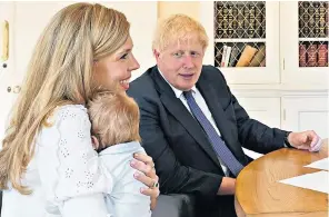  ??  ?? The Prime Minister, his fiancée Carrie Symonds and their son Wilfred – who has inherited his father’s mop of blond hair – were photograph­ed together for the first time during a video call in which they thanked the midwives who helped deliver the child at University College Hospital, in London, in April