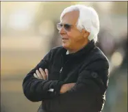  ?? Charlie Riedel / Associated Press ?? Trainer Bob Baffert watches a morning workout at Churchill Downs Tuesday in Louisville, Ky.