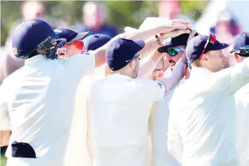  ?? — AFP photo ?? England's James Vinc (C) celebrates New Zealand's Tom Latham being caught with teammates during day five of the second cricket Test match between New Zealand and England at Hagley Oval in Christchur­ch on April 3, 2018.