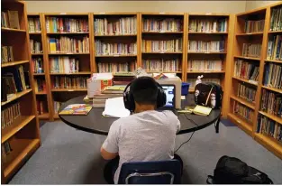  ?? JAE C. HONG — THE ASSOCIATED PRESS ?? A Los Angeles Unified School District student attends an online class at the Boys & Girls Club of Hollywood on Aug. 26. A new federal survey finds that the share of students learning in-person has varied greatly by region and race.