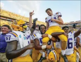  ?? MATTHEW HINTON — THE ASSOCIATED PRESS ?? LSU place kicker Connor Culp (34) is lifted on the shoulders of teammates Jibrail Abdul-Aziz (58) and Cameron Gamble (36) after the unranked Tigers beat No. 10 Auburn 27-23 in Baton Rouge, La., Saturday.