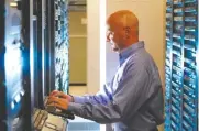  ?? STAFF FILE PHOTO ?? Rich Carpenter, manager of network operations for EPB, uses a Fi TV video monitoring station in the room that houses the heart of EPB’s fiber network.