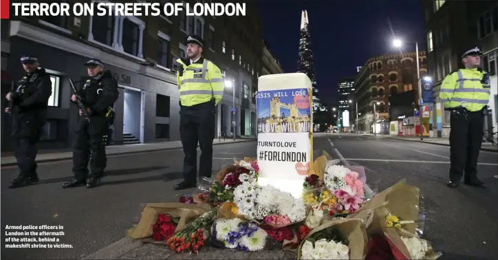  ??  ?? Armed police officers in London in the aftermath of the attack, behind a makeshift shrine to victims.