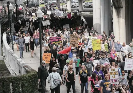  ?? Elizabeth Conley / Houston Chronicle ?? Protesters march from Buffalo Bayou Park to Houston City Hall. City leaders, including the mayor and police chief, attended.