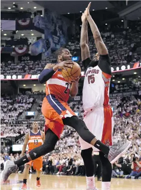  ?? FRANK GUNN/The Canadian Press ?? Washington Wizards’ John Wall drives for the basket as the Raptors’ Amir Johnson defends
during second-half NBA playoff action in Toronto on Tuesday night.