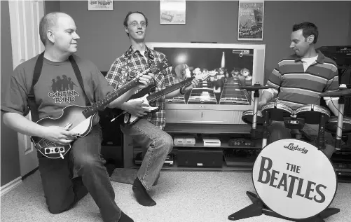  ?? Bruce Edwards/ Edmonton Journal/ File ?? Jason Konoza, left, and friends Mark White and Karl Kohler play Rock Band in 2010. Konoza says he used his mobile phone to buy tickets to concerts by Paul McCartney and Taylor Swift. He got tickets to the upcoming Mumford & Sons show in a pre-sale.