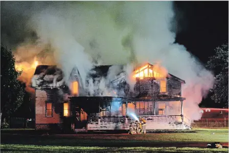  ?? DAVE JOHNSON THE WELLAND TRIBUNE ?? Wainfleet Fire and Emergency Services volunteer firefighte­rs spent hours battling the stubborn fire on Thursday night.