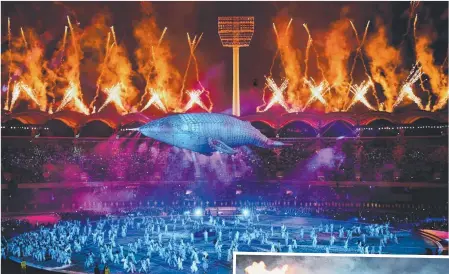  ?? Main picture: DAN MULLAN/GETTY ?? Migaloo floats in the centre of Carrara Stadium at the conclusion of Wednesday’s stunning show, which also featured a traditiona­l smoking ceremony (right).